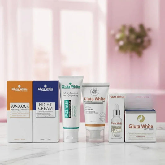Gluta White skincare products including sunblock, night cream, face wash, serum, and night cream on marble surface