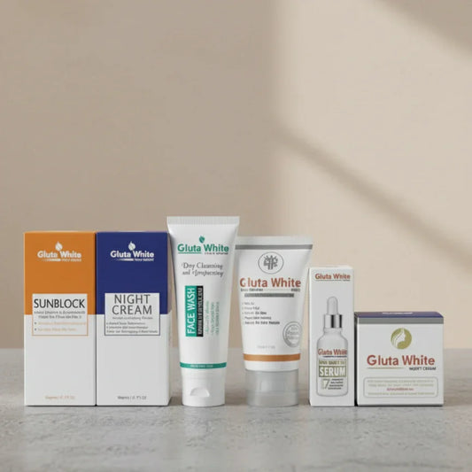 Gluta White skincare set including sunblock, night cream, face wash, whitening cream, serum, and night cream box on grey surface