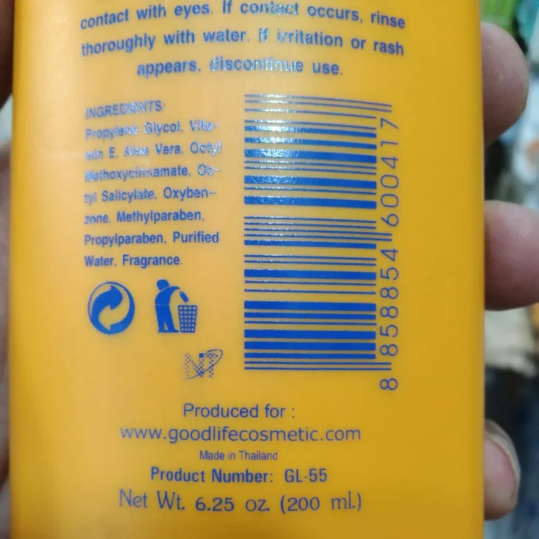 Close-up of back label on yellow Goodlife Cosmetic sunscreen bottle detailing ingredients, barcode, and product info