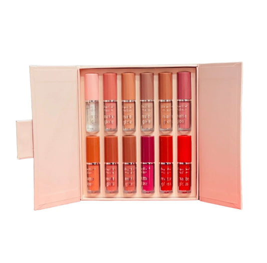 Set of lip glosses in a pink case on a white background