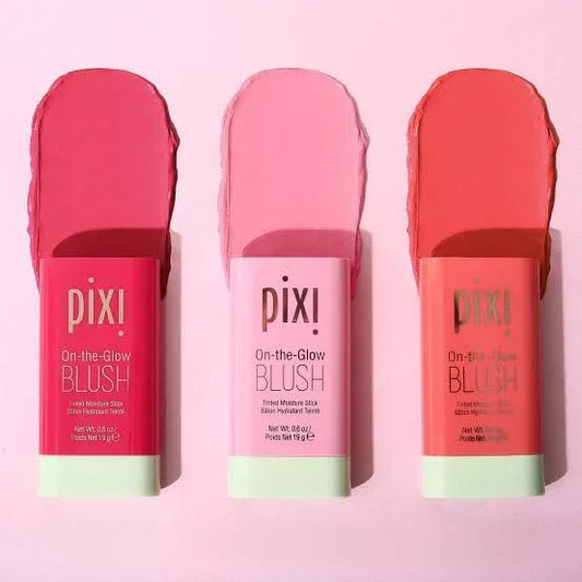 Pixi On-the-Glow Blush tinted moisture sticks in three pink shades on a pink background
