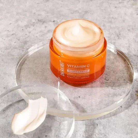 Open jar of Dr. Rashel Vitamin C night cream on clear round tray with cream texture on lid