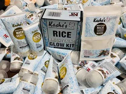Kashe’s Rice Brightening Glow Kit surrounded by multiple brightening rice scrub, face wash, and powder organic mask tubes