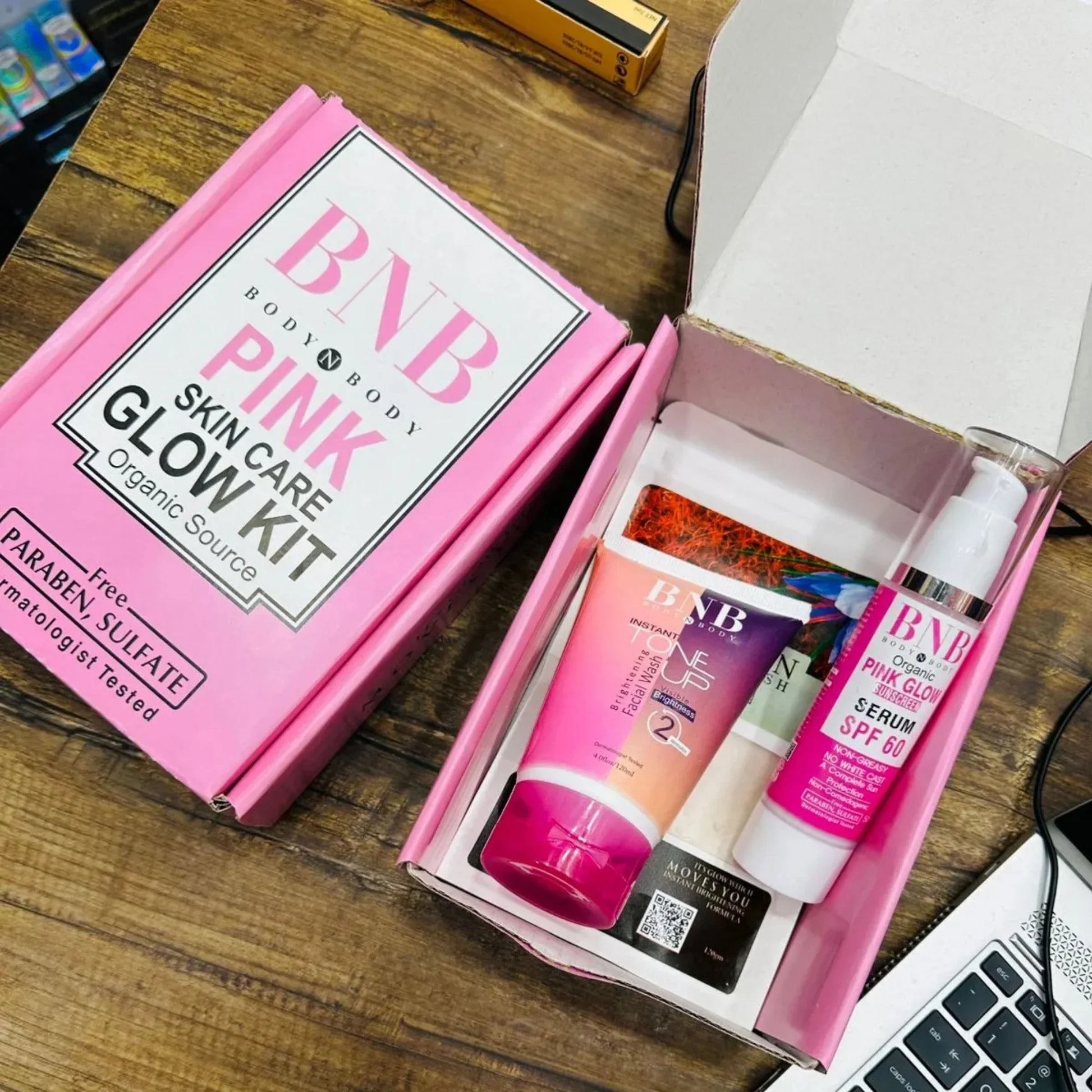 BNB Pink Skin Care Glow Kit with Brightening Facial Wash and SPF 60 Serum on wooden table
