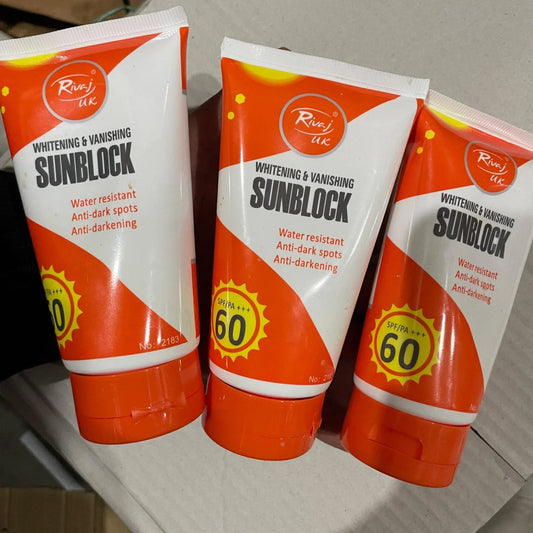 Three tubes of sunblock cream with SPF 60 on a cardboard surface.