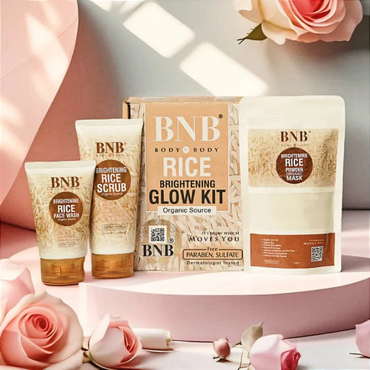 BNB Rice Brightening Glow Kit with face wash, scrub, and powder mask on pink platform with roses